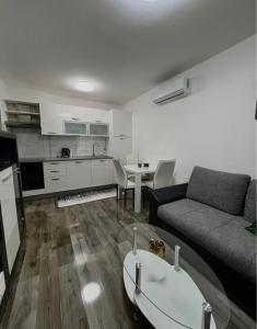 a living room with a couch and a table at Jadranka in Vinkovci
