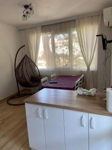a room with a bed in a room with a window at Emis apartment in Targovishte