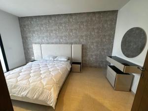 a bedroom with a large bed and a mirror at Villa Donia in Mezraya