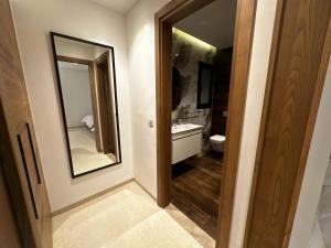 a bathroom with a sink and a toilet and a mirror at Villa Donia in Mezraya