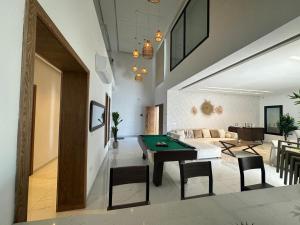 a living room with a pool table and a couch at Villa Donia in Mezraya