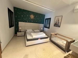 a bedroom with two beds and a painting on the wall at Villa Donia in Mezraya
