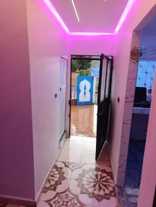 a pink hallway with a door and a tile floor at Casa Yessef Akchour in Akchour