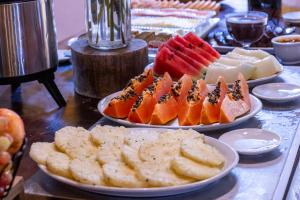 a table with three plates of different types of food at Villa Baepi Pousada Ilhabela in Ilhabela +16 photos