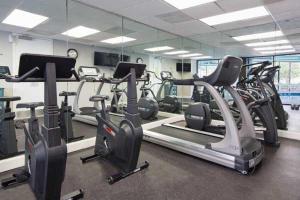 a gym with several treadmills and cardio machines at JS Luxury Vacation in Orlando