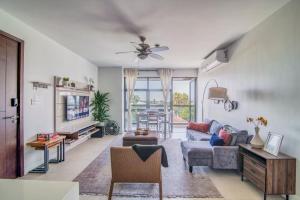 a living room with a couch and a table at Airy Modern 2br Condo Rooftop Pool in Kingston
