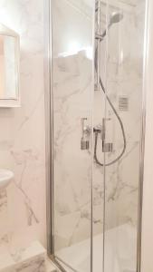 a bathroom with a shower with a glass door at Studio de la maison Lilas in Pila-Canale