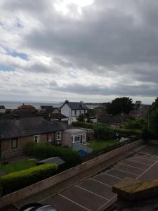 a view of a city with houses and the ocean at Aboukir Hotel in Panbride