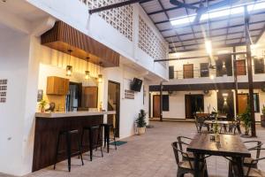 an empty patio with tables and chairs in a building at El Bakatir in Banyuwangi