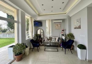a living room with a couch and chairs at HOTEL BRIZ - Free Parking in Burgas