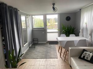 a living room with a white table and a white couch at Apartament Ostrzyce in Ostrzyce
