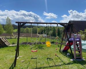 a playground with a swing set in a yard at Apartament Ostrzyce in Ostrzyce