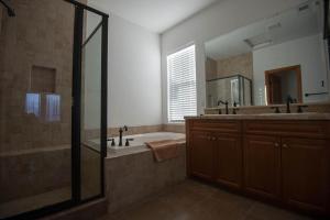 a bathroom with a tub and a large mirror at Pool Side El Dorado Ranch Rental Condo #37-3 in San Felipe