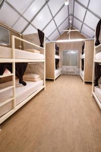 a large room with bunk beds in a tent at 1000 Stars Riverside Hostel in Ban Khrae Yao Doi Bo