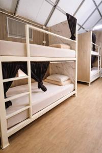 a room with bunk beds in a tent at 1000 Stars Riverside Hostel in Ban Khrae Yao Doi Bo