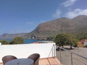 a balcony with a view of a lake and mountains at Hotel Strela Tarrafal in Tarrafal
