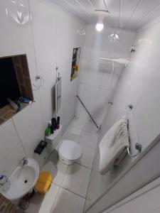 a white bathroom with a toilet and a sink at Casa completa aconchegante proximo a praia in São Luís
