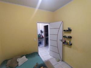 a room with a bedroom with a mirror and a door at Casa completa aconchegante proximo a praia in São Luís +3 photos