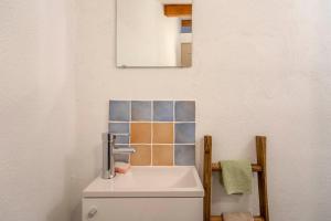 a bathroom with a sink and a mirror at Maison - Le Petit Bussac in Aigne +20 photos
