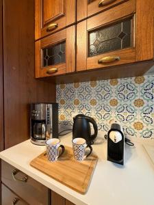 a kitchen counter with two coffee mugs on a cutting board at Sea Breeze Terrace in Monopoli