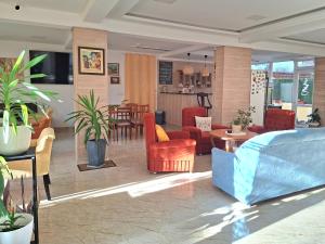 a living room with a couch and chairs at Hotel VIVA in Sofia