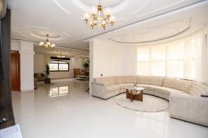 a large living room with couches and a table at Villa d'exception - Piscine à débordement - Vue sur la mer - Barbecue - Salle de sport - Jusqu'à 12 personnes in Feddane Chappo