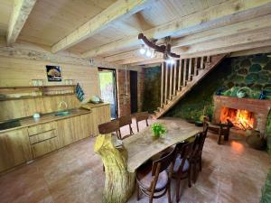 a kitchen and dining room with a table and a fireplace at kirke in Tsesi +29 photos