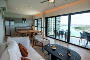 a living room with a couch and a table at Ocean's Embrace and unforgetful sunsets in Progreso