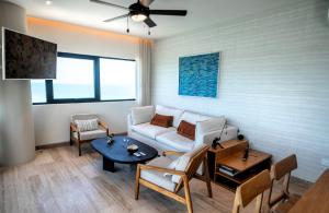 a living room with a couch and a table at Ocean's Embrace and unforgetful sunsets in Progreso +66 photos