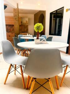 a dining room with a white table and chairs at Hotel Fuente Real Popayán in Popayan
