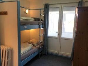 a room with three bunk beds and a window at AUBERGE RIVA BELLA in Le Touquet-Paris-Plage +40 photos