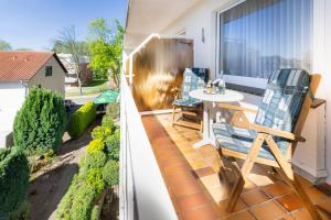 a patio with two chairs and a table on a balcony at Akzent Hotel Berlin Ihr ThermePlus Hotel in Bad Bevensen