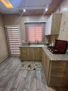 a kitchen with a sink and a counter top at Studio de vacance à louer in Monastir +4 photos