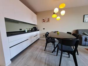 a kitchen and dining room with a table and chairs at Immobillario - Casa Luna in Domaso