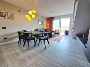 a dining room and living room with a table and chairs at Immobillario - Casa Luna in Domaso +15 photos