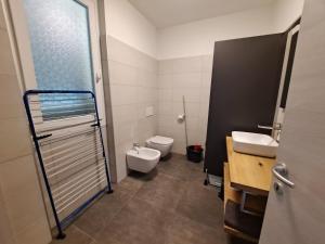 a bathroom with a toilet and a sink at Immobillario - Casa Luna in Domaso