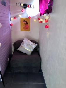 a small room with a couch in a room with lights at Le Chant des Elfes in Samer +7 photos