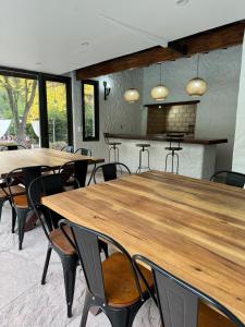 a conference room with wooden tables and chairs at Terracampo Apart in Ciudad Lujan de Cuyo