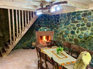 a dining room with a table and a fireplace at kirke in Tsesi