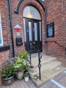 a door to a brick building with plants in front of it at Crescent Lodge Guest House in Whitby