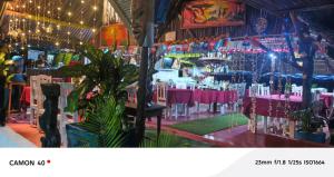 a restaurant with pink tables and chairs and lights at Piscine bimoko in Nosy Be +252 photos