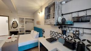 a bedroom with a bed and a desk in a room at NESTOR LUXURY Studios in Vathi