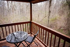 a table and two chairs on a wooden deck at Buckeye Bungalow in Logan