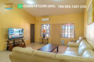 a living room with a couch and a flat screen tv at Paradise home in Rancho Percebu in San Felipe +26 photos