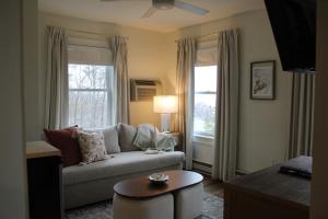 a living room with a couch and a window at The Trident Inn in Ogunquit
