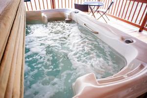 a hot tub on a deck with water in it at Buckeye Bungalow in Logan