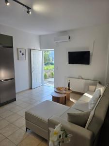 a living room with a couch and a table at Archanes Cozy Retreat in Archanes