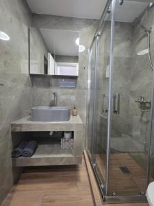 a bathroom with a sink and a shower at Archanes Cozy Retreat in Archanes +10 photos