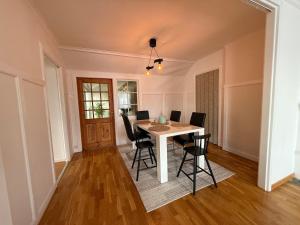 a dining room with a table and chairs at Spacious flat 15 min to the beach in Falkenberg