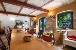 a dining room with a wooden table and chairs at Seminarhof Mollandur in Bochow